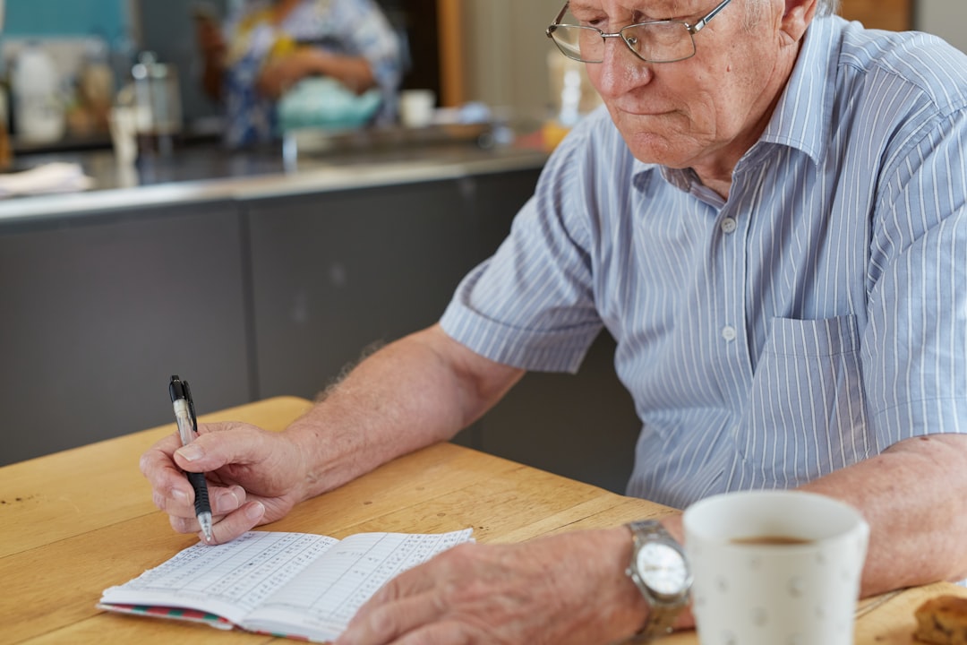 An older South African man writing down blood glucose test results for Type 1 diabetes or Type 2 diabetes.
